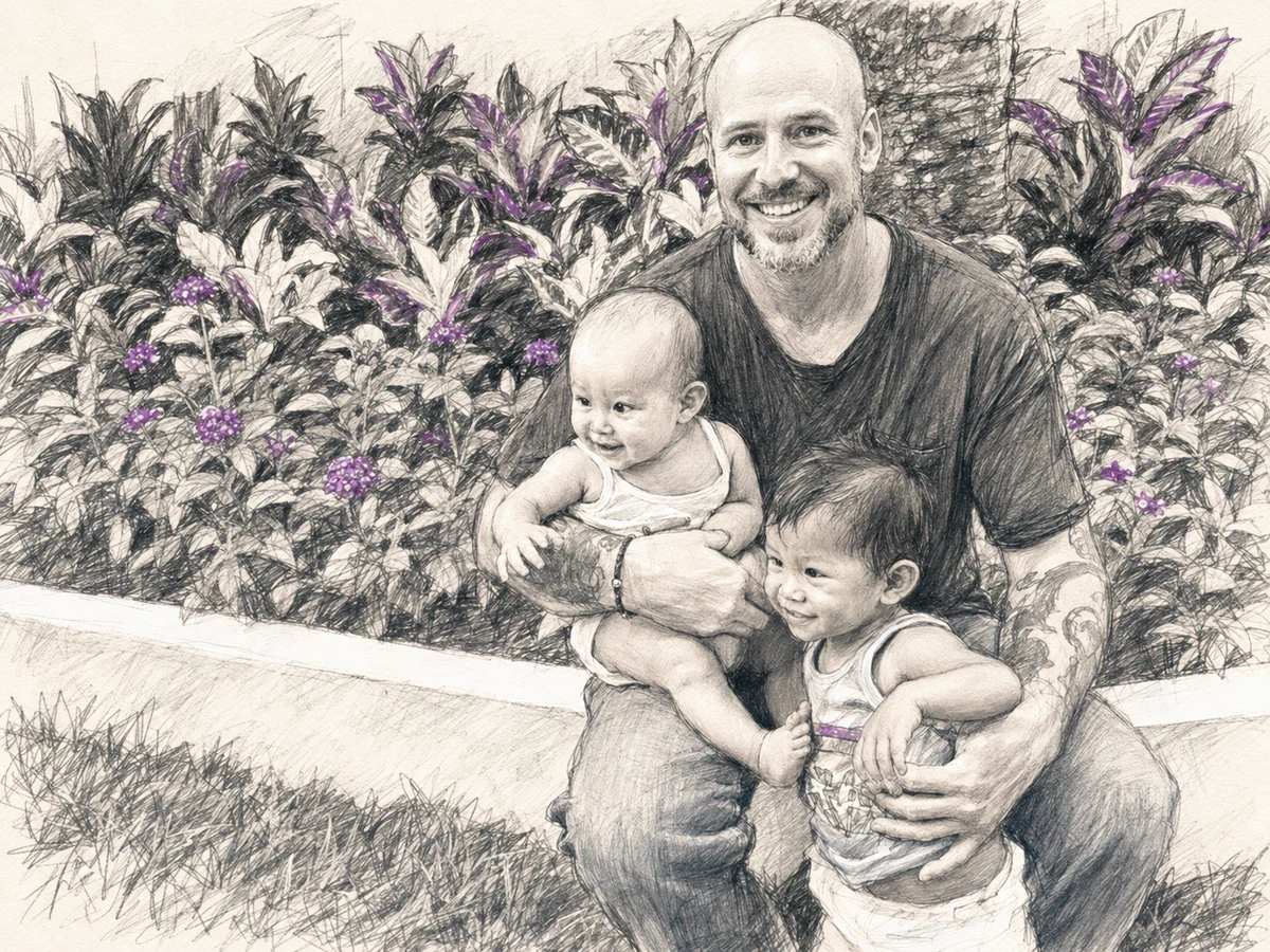 Younger Will holding baby Alexa and toddler Christopher among bright tropical flowers in the Philippines.